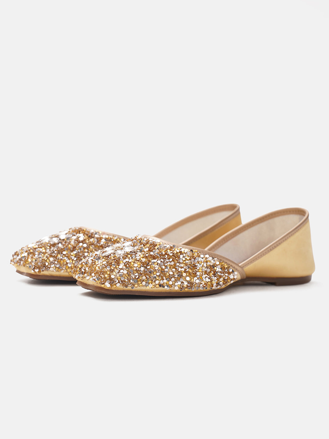 traditional juttis heavily embellished with sequins and a large floral motif at the toe
Golden