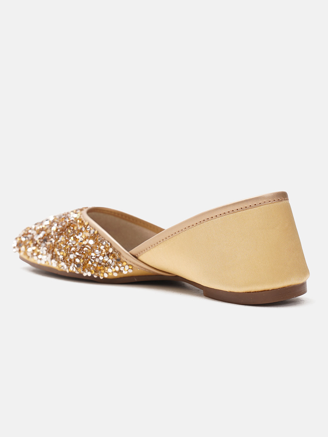 traditional juttis heavily embellished with sequins and a large floral motif at the toe
Golden