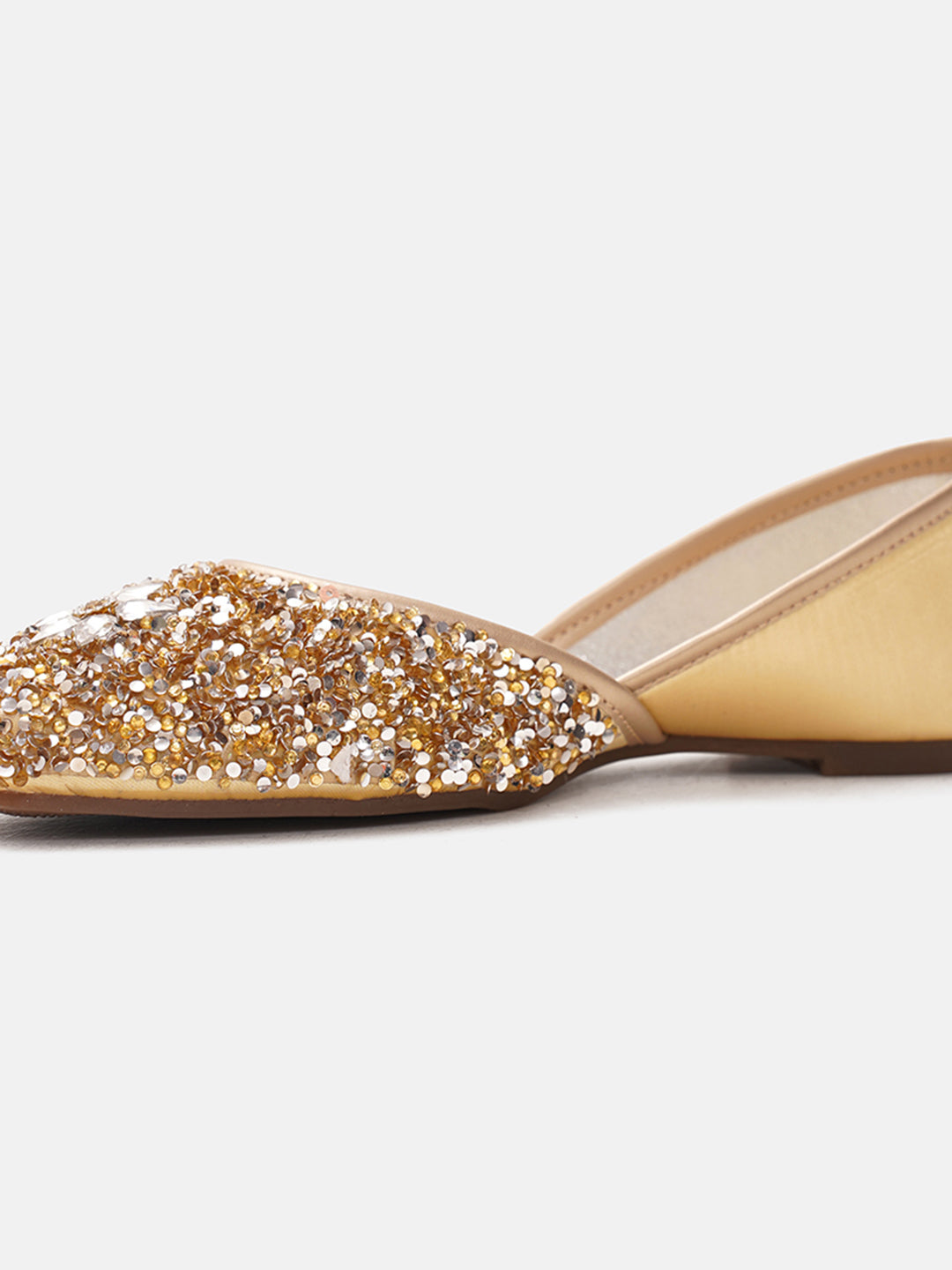 traditional juttis heavily embellished with sequins and a large floral motif at the toe
Golden