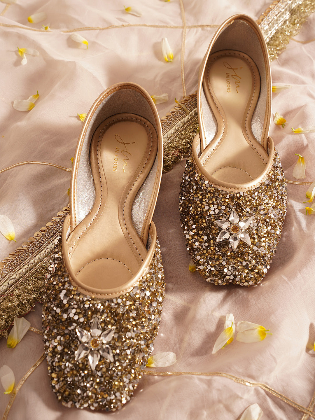 traditional juttis heavily embellished with sequins and a large floral motif at the toe
Green