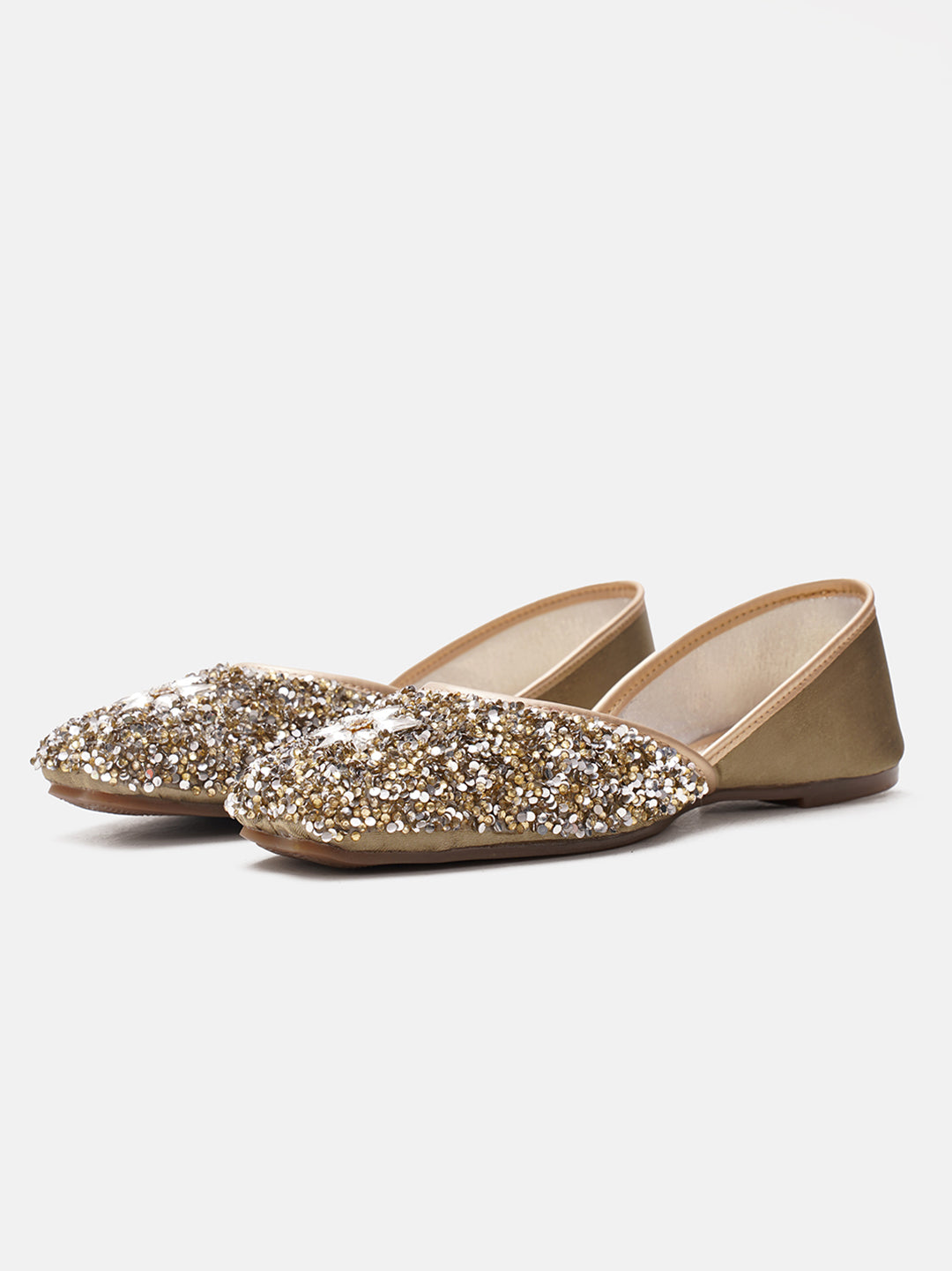 traditional juttis heavily embellished with sequins and a large floral motif at the toe
Green