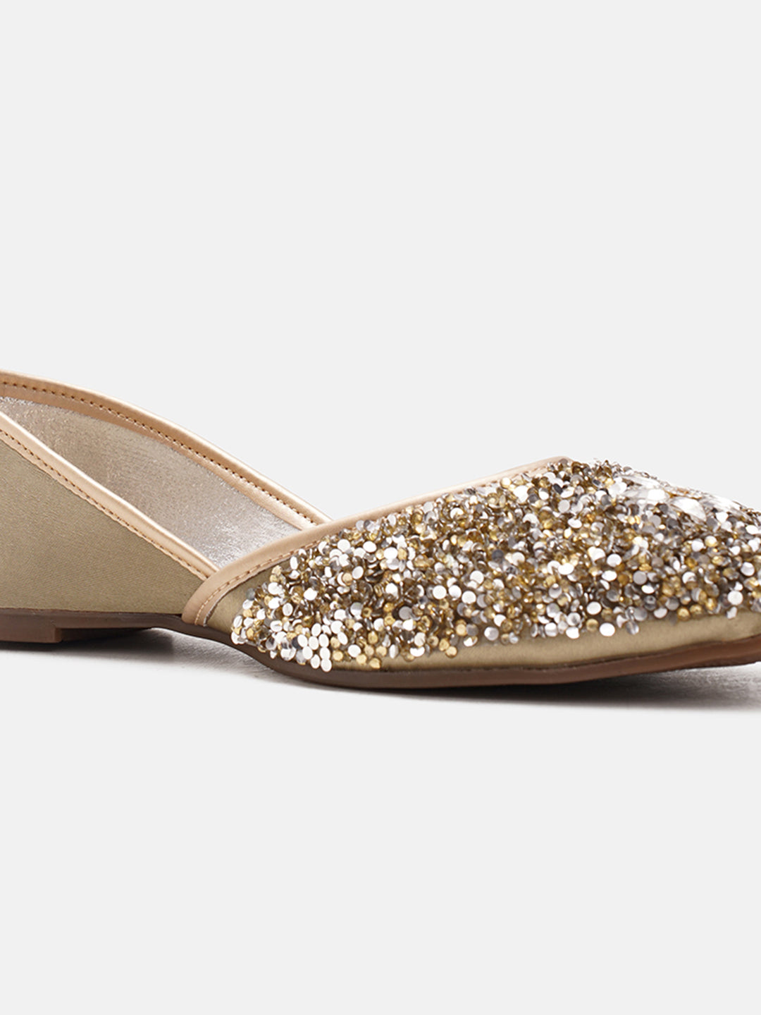 traditional juttis heavily embellished with sequins and a large floral motif at the toe
Green