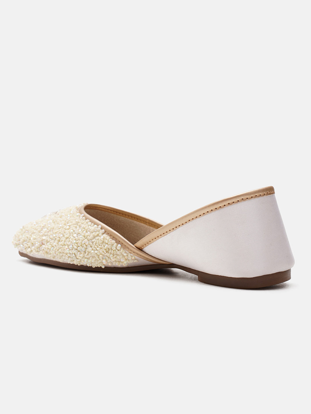 traditional juttis heavily embellished with sequins and a large floral motif at the toe
White