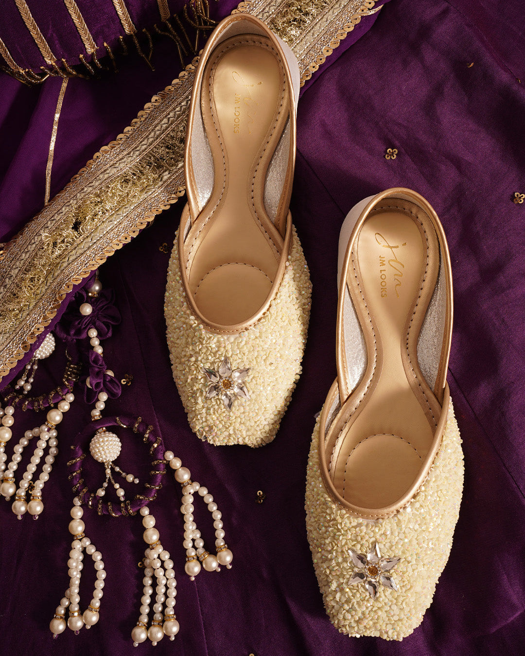 traditional juttis heavily embellished with sequins and a large floral motif at the toe
White