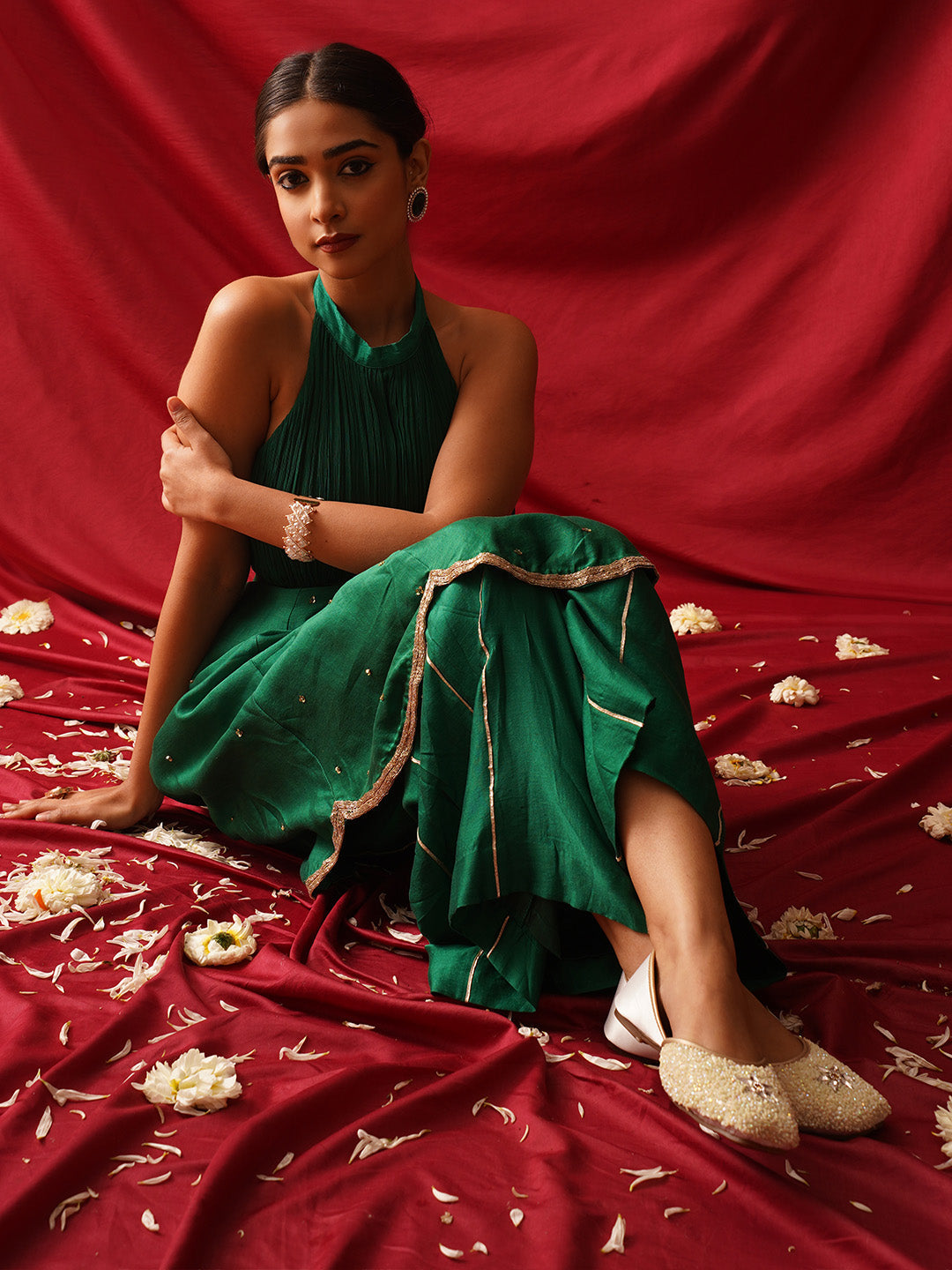 traditional juttis heavily embellished with sequins and a large floral motif at the toe
White
