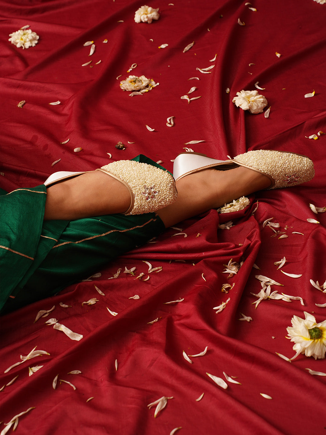 traditional juttis heavily embellished with sequins and a large floral motif at the toe
White