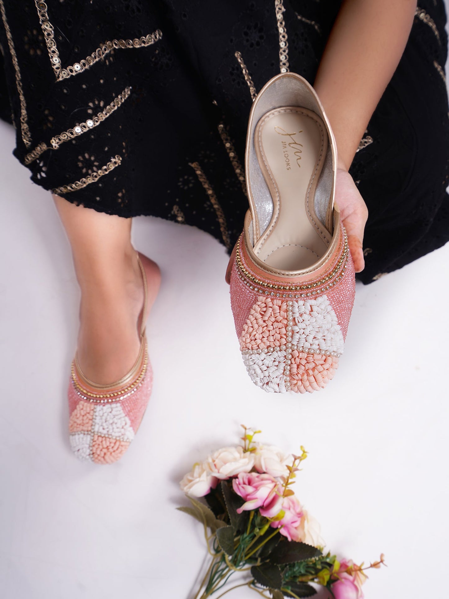 juttis featuring a checkered pattern made from beads
Peach