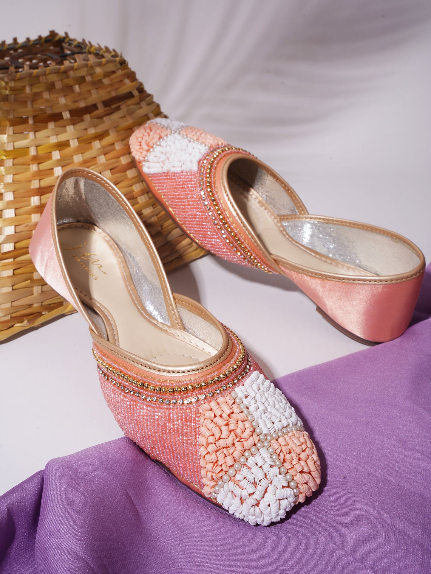 juttis featuring a checkered pattern made from beads
Peach