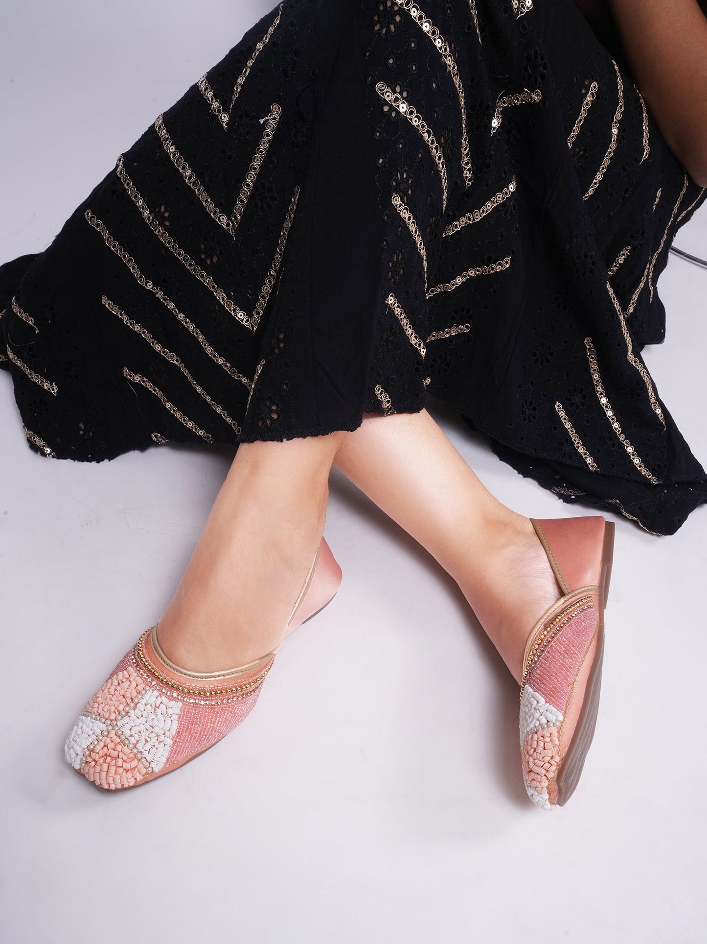 juttis featuring a checkered pattern made from beads
Peach