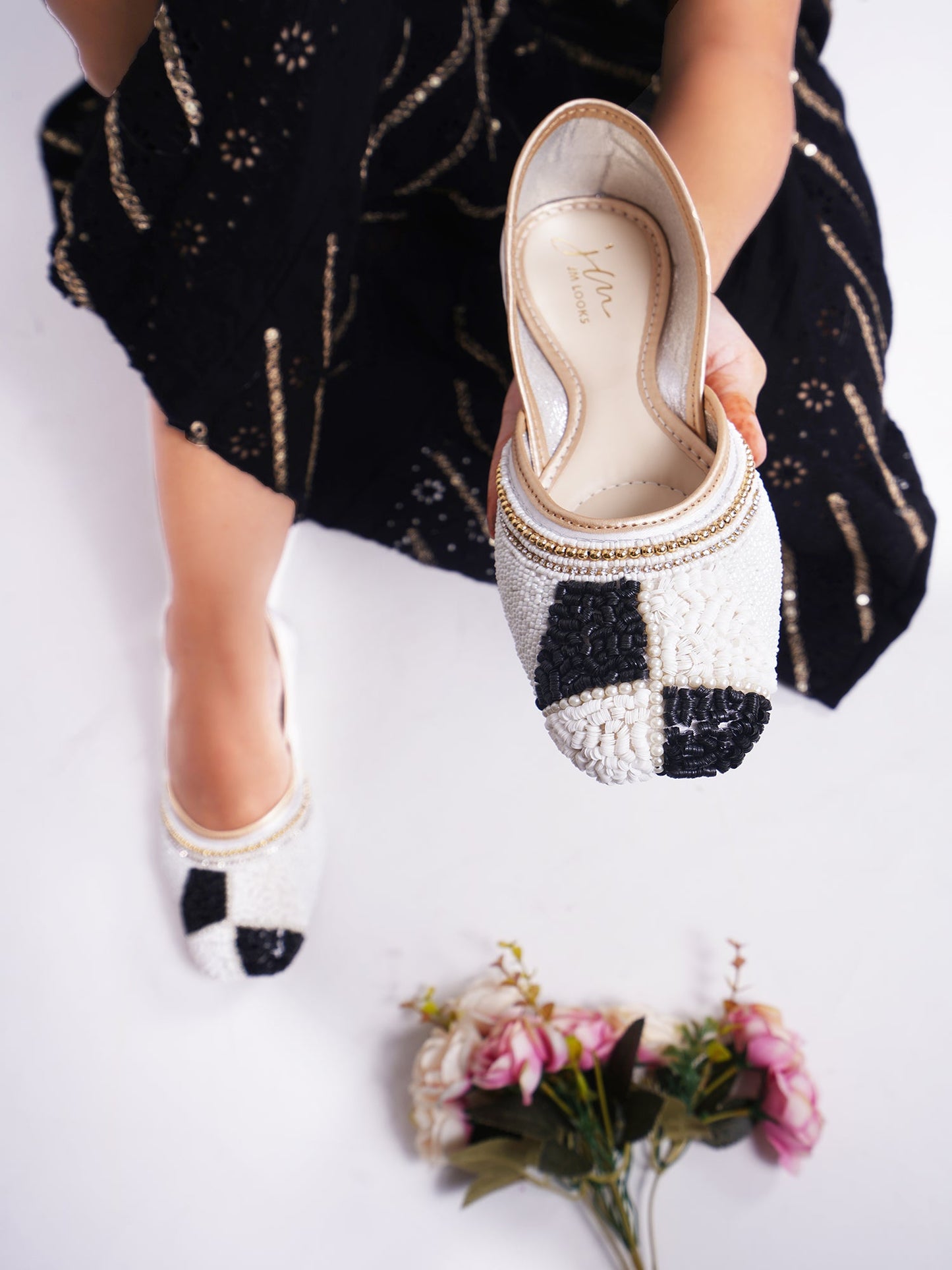 juttis featuring a checkered pattern made from beads
White