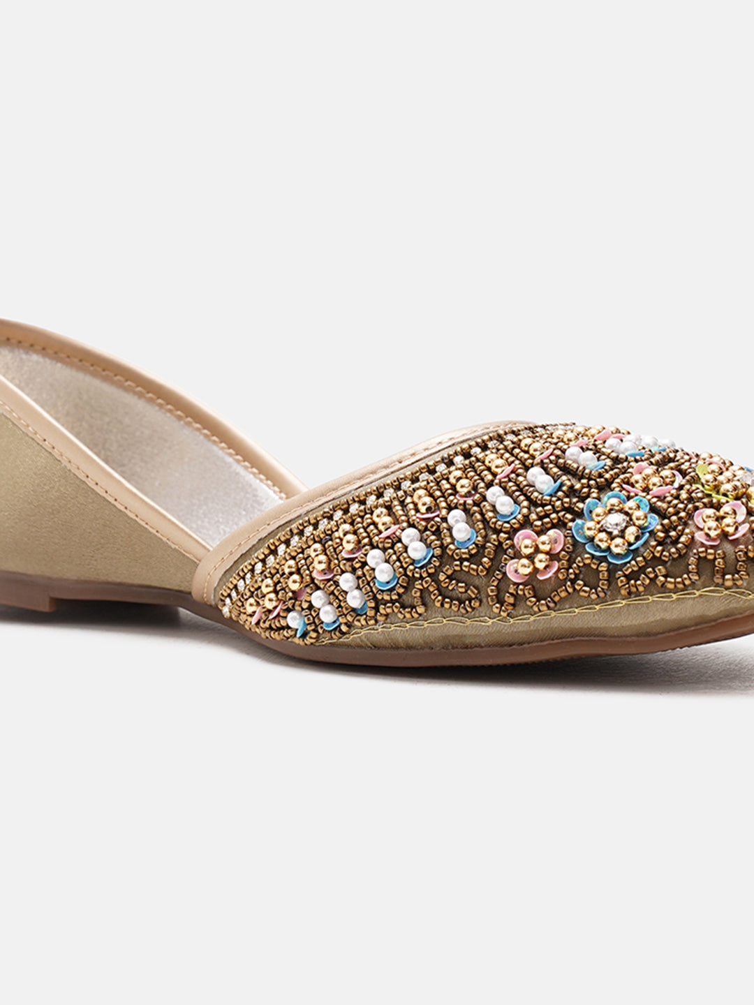 traditional juttis with intricate floral embroidery and detailed beadwork on the upper
Green