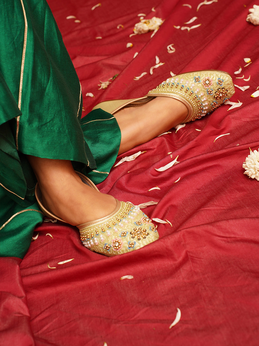 traditional juttis with intricate floral embroidery and detailed beadwork on the upper
Pista