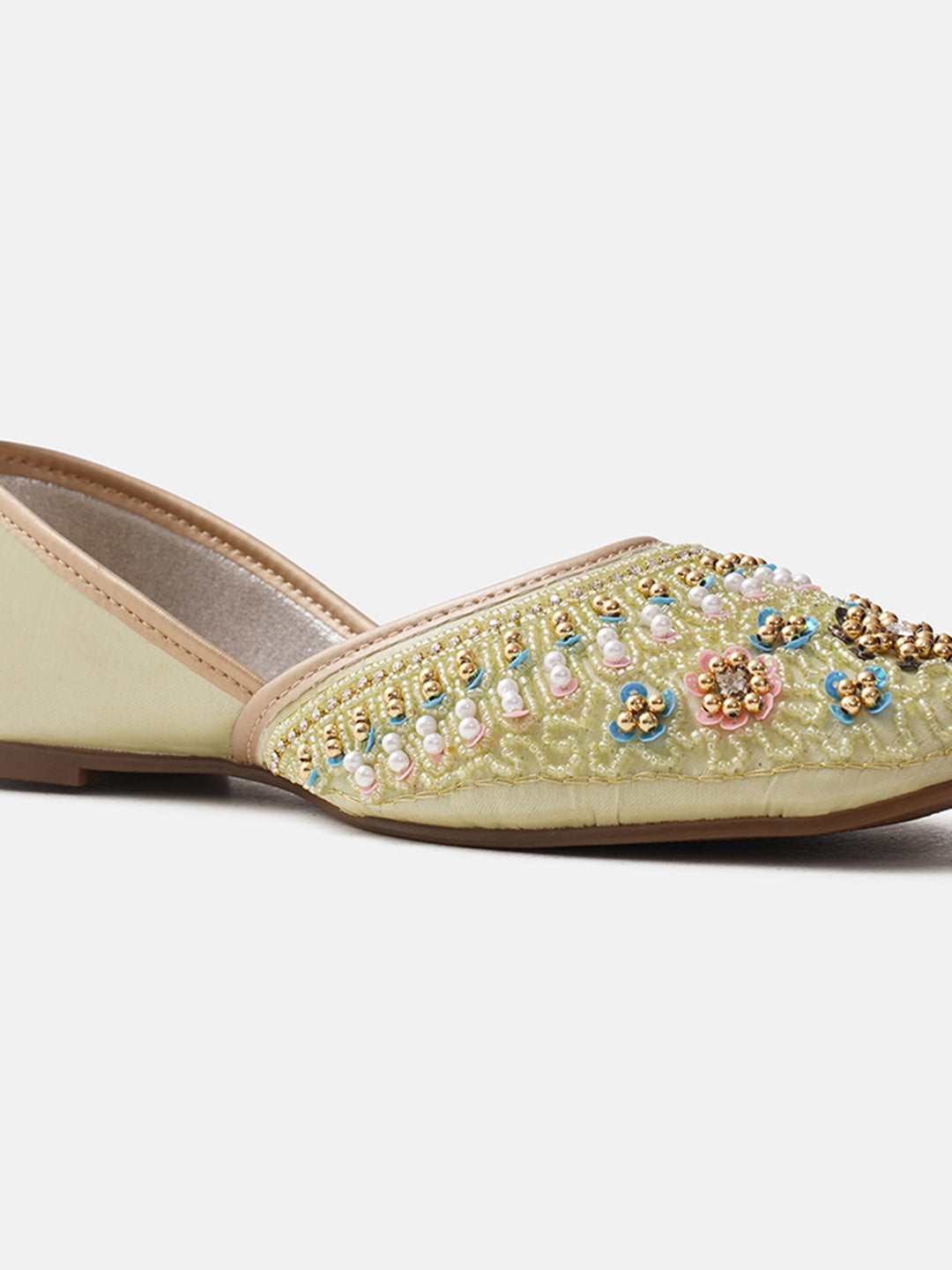 traditional juttis with intricate floral embroidery and detailed beadwork on the upper
Pista