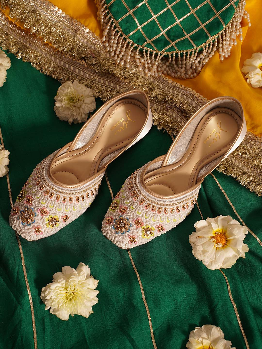 traditional juttis with intricate floral embroidery and detailed beadwork on the upper
White