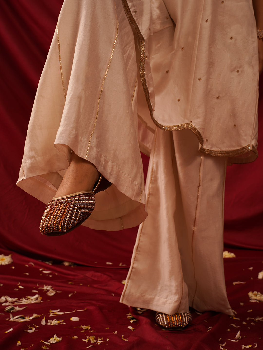 traditional juttis with intricate striped beadwork covering the entire upper
Copper