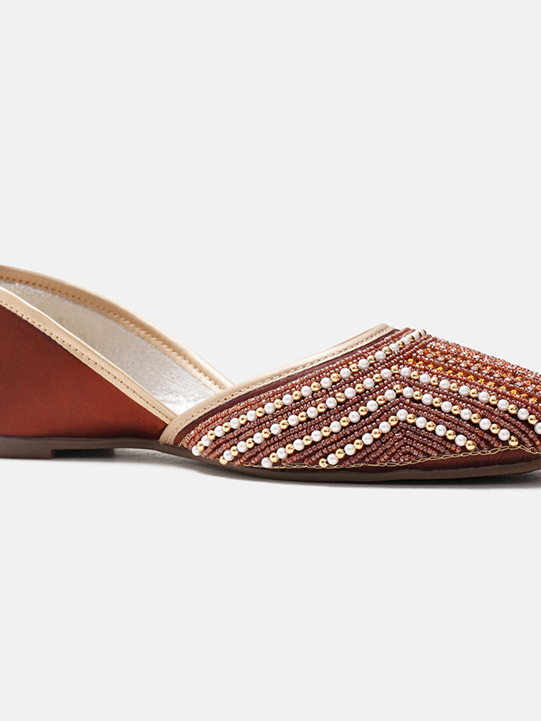 traditional juttis with intricate striped beadwork covering the entire upper
Copper