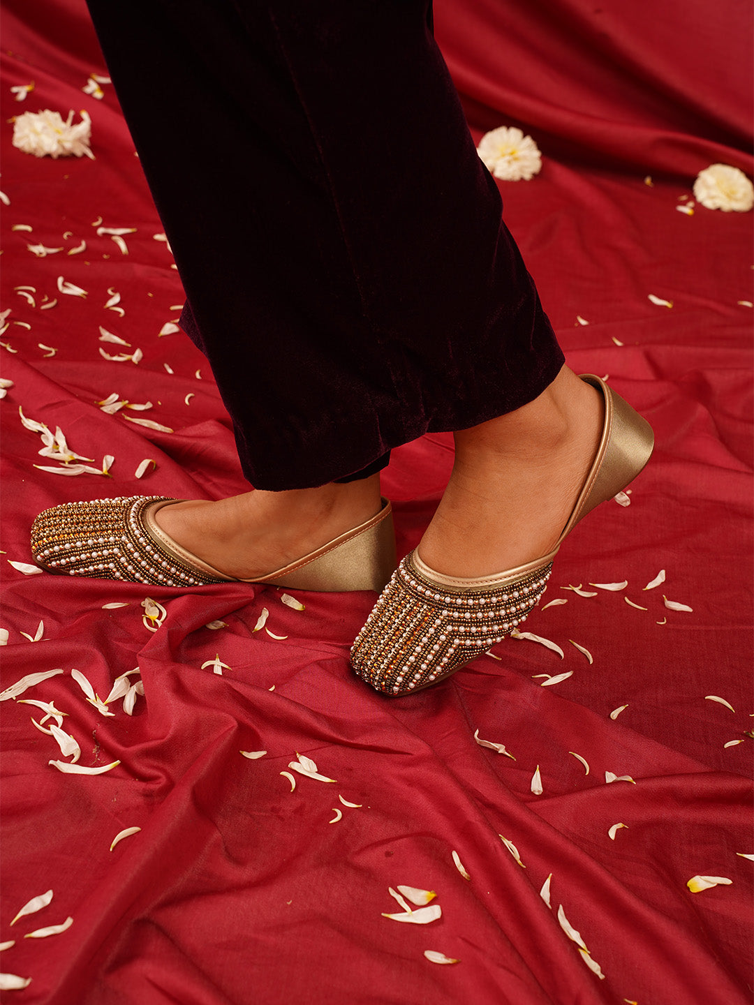 traditional juttis with intricate striped beadwork covering the entire upper
White