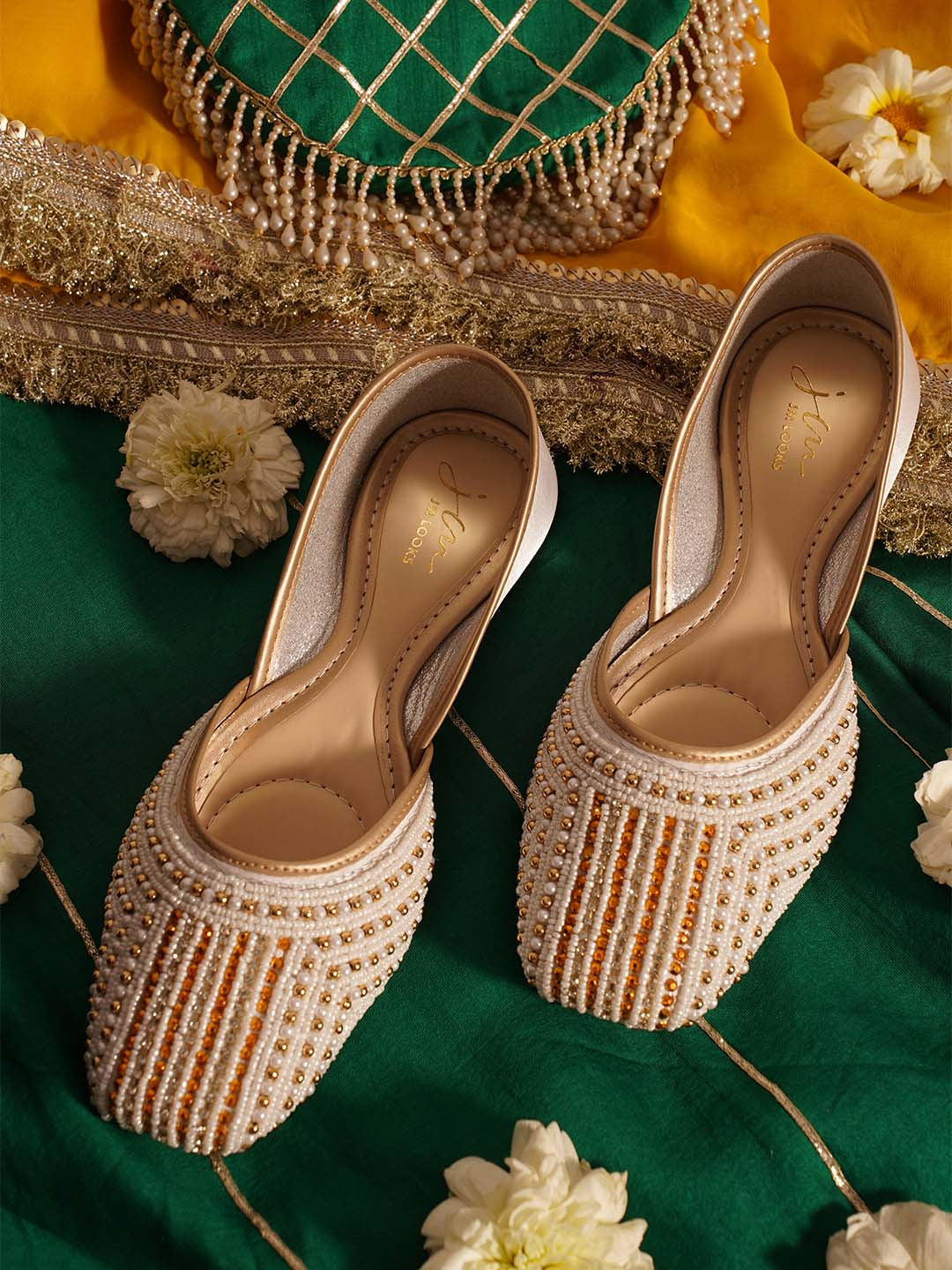 traditional juttis with intricate striped beadwork covering the entire upper
Green