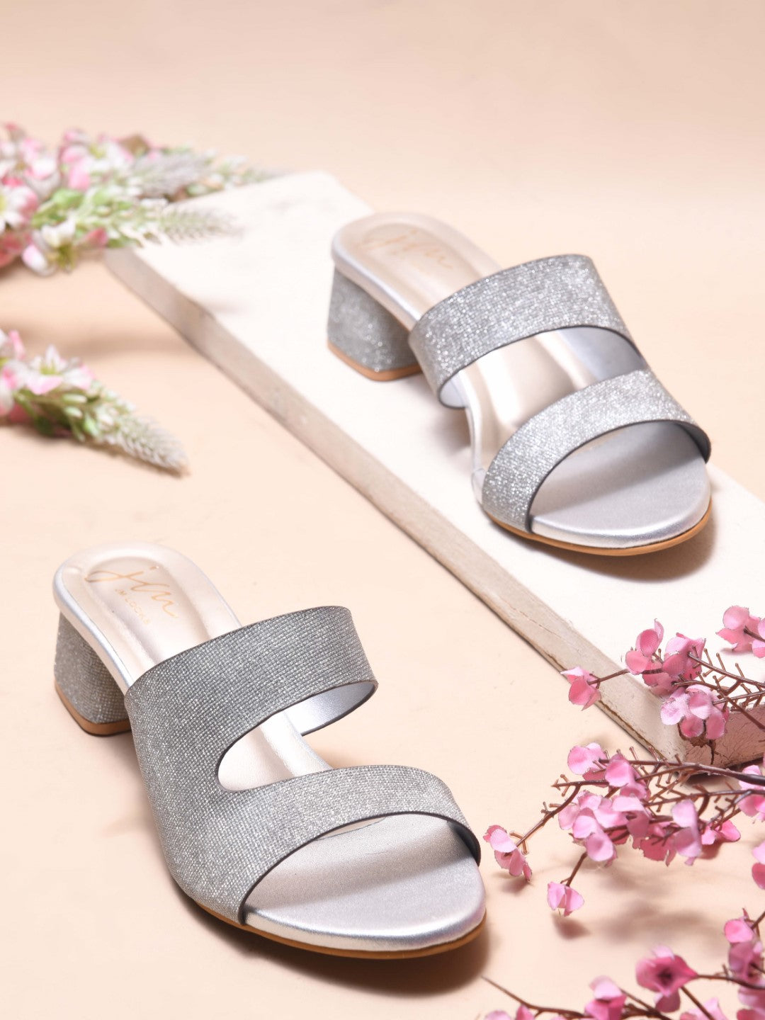Jm Looks wedge slides featuring a decorative bow and a small charm
Silver