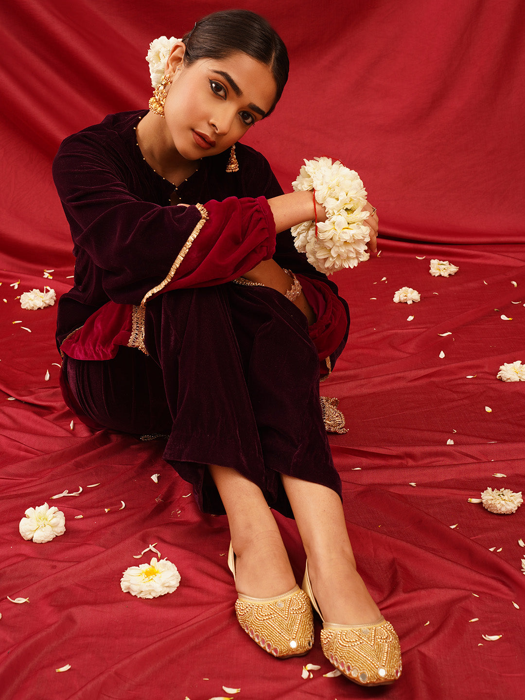 traditional juttis heavily embellished with pearls and beads on the upper
Golden