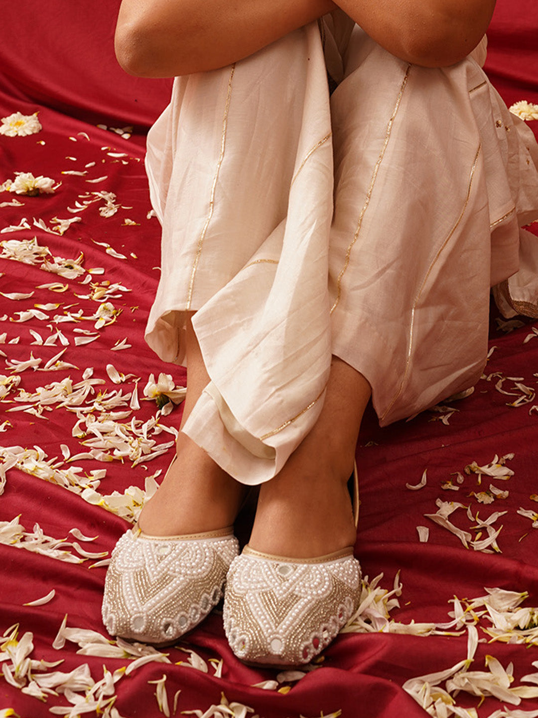 traditional juttis heavily embellished with pearls and beads on the upper
Green