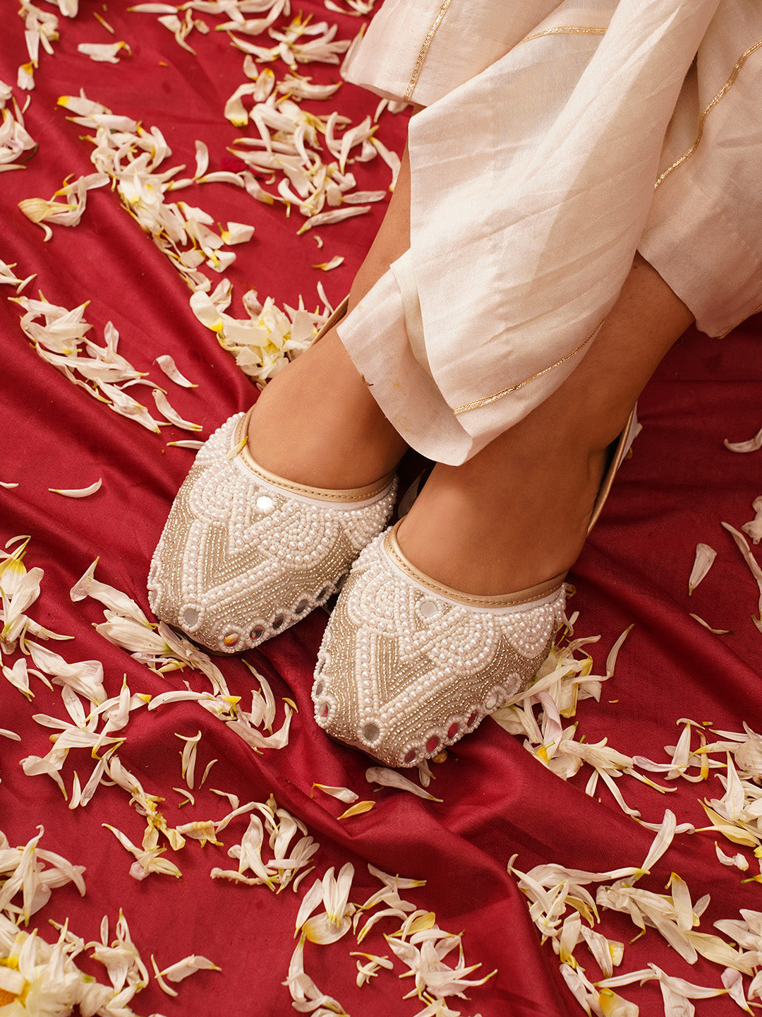 traditional juttis heavily embellished with pearls and beads on the upper
Green