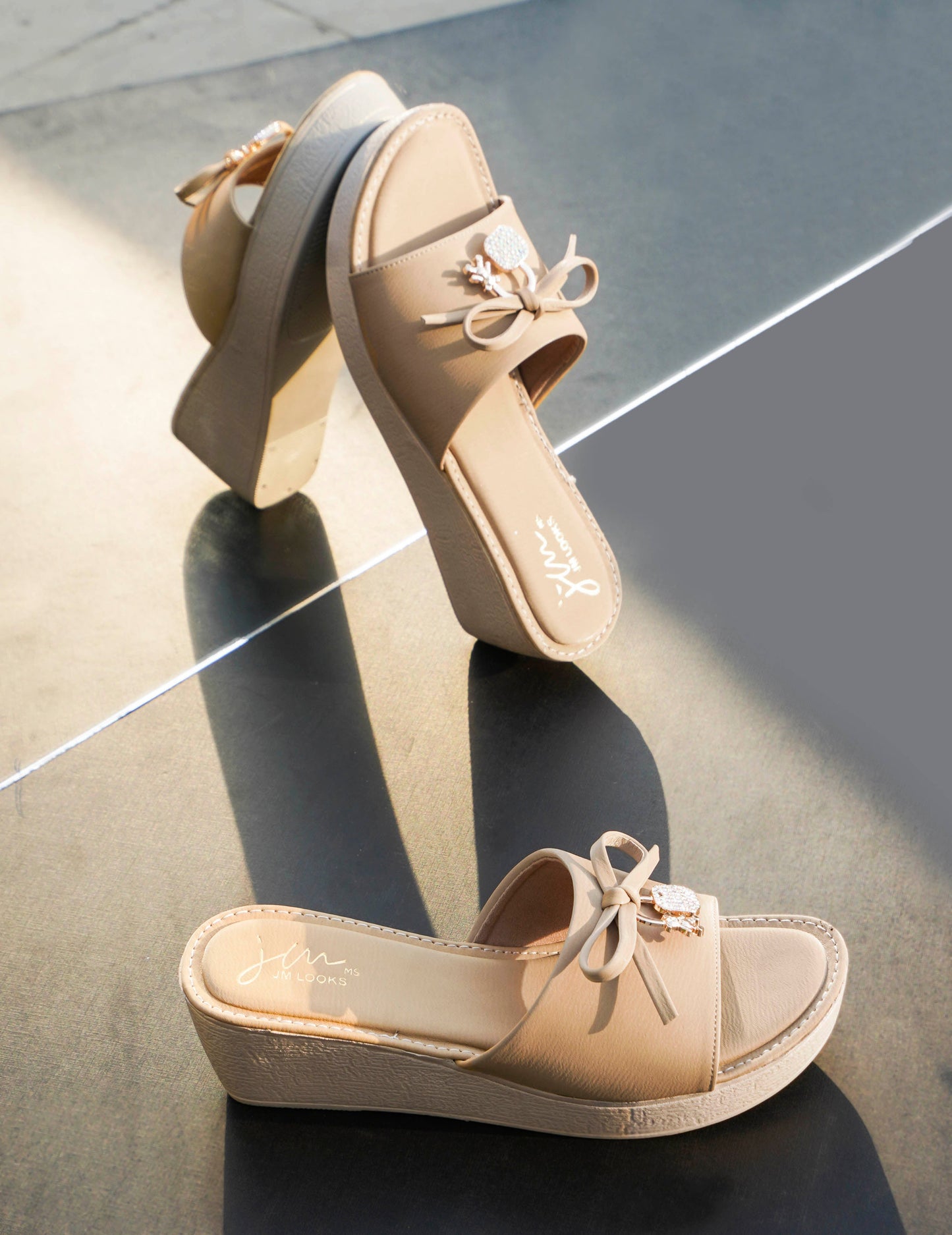 Jm Looks wedge slides with a decorative bow on the strap
Beige