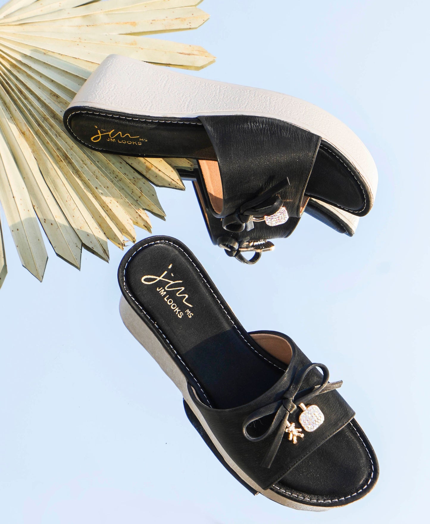 Jm Looks wedge slides with a decorative bow on the strap
Black