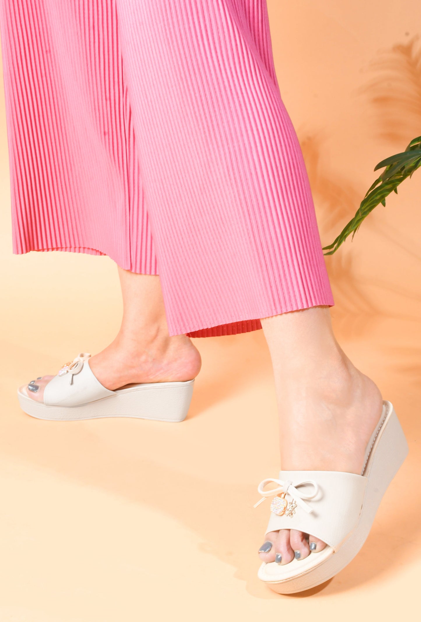 Jm Looks wedge slides with a decorative bow on the strap
Cream