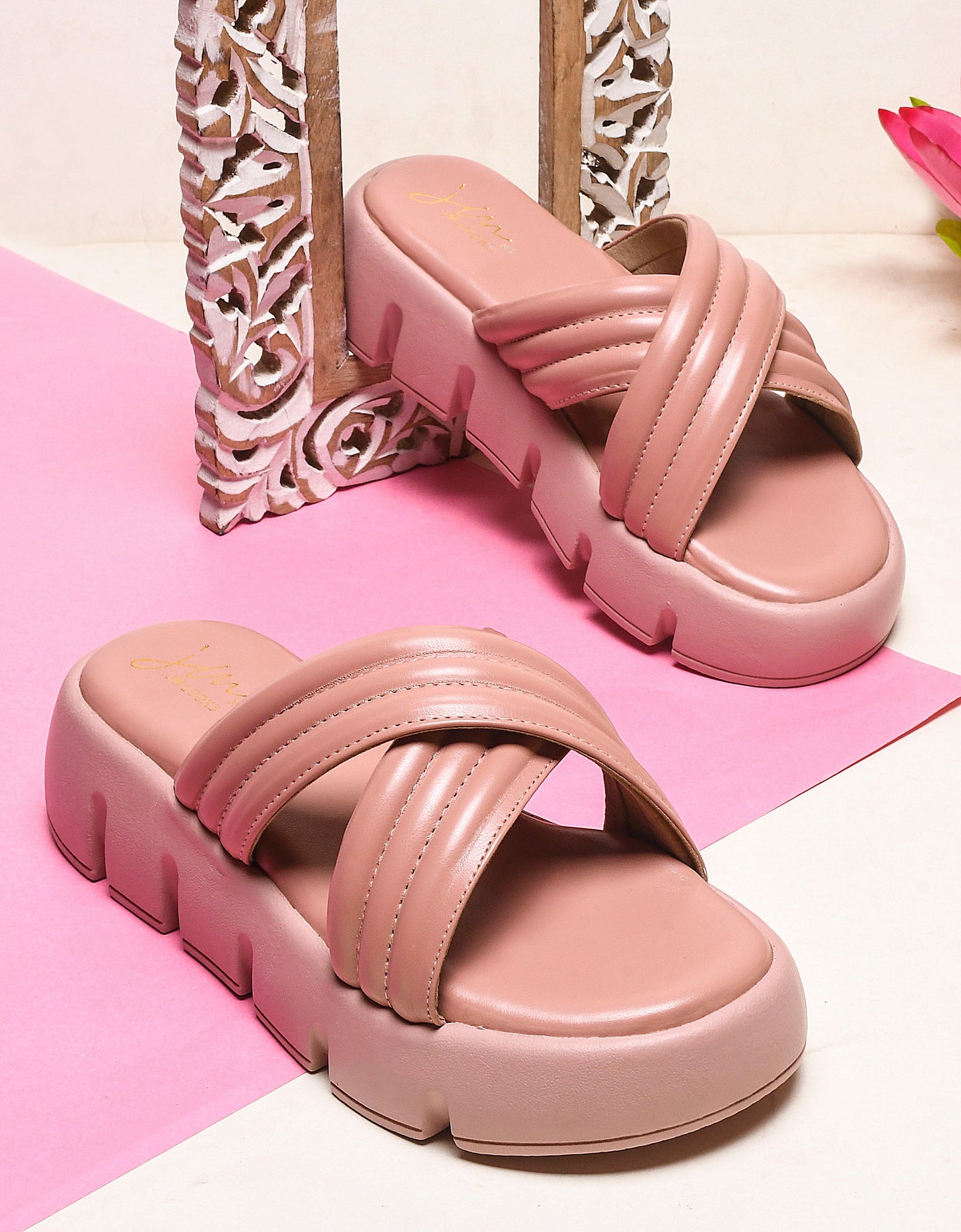 women's platform slides with wide, padded crisscross straps and a chunky lug sole
Peach