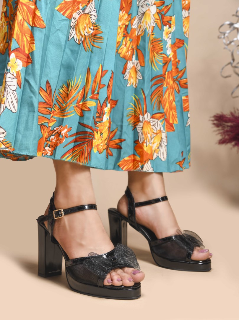 Jm Looks platform heels with a sheer bow detail on the front strap and an ankle strap
Black