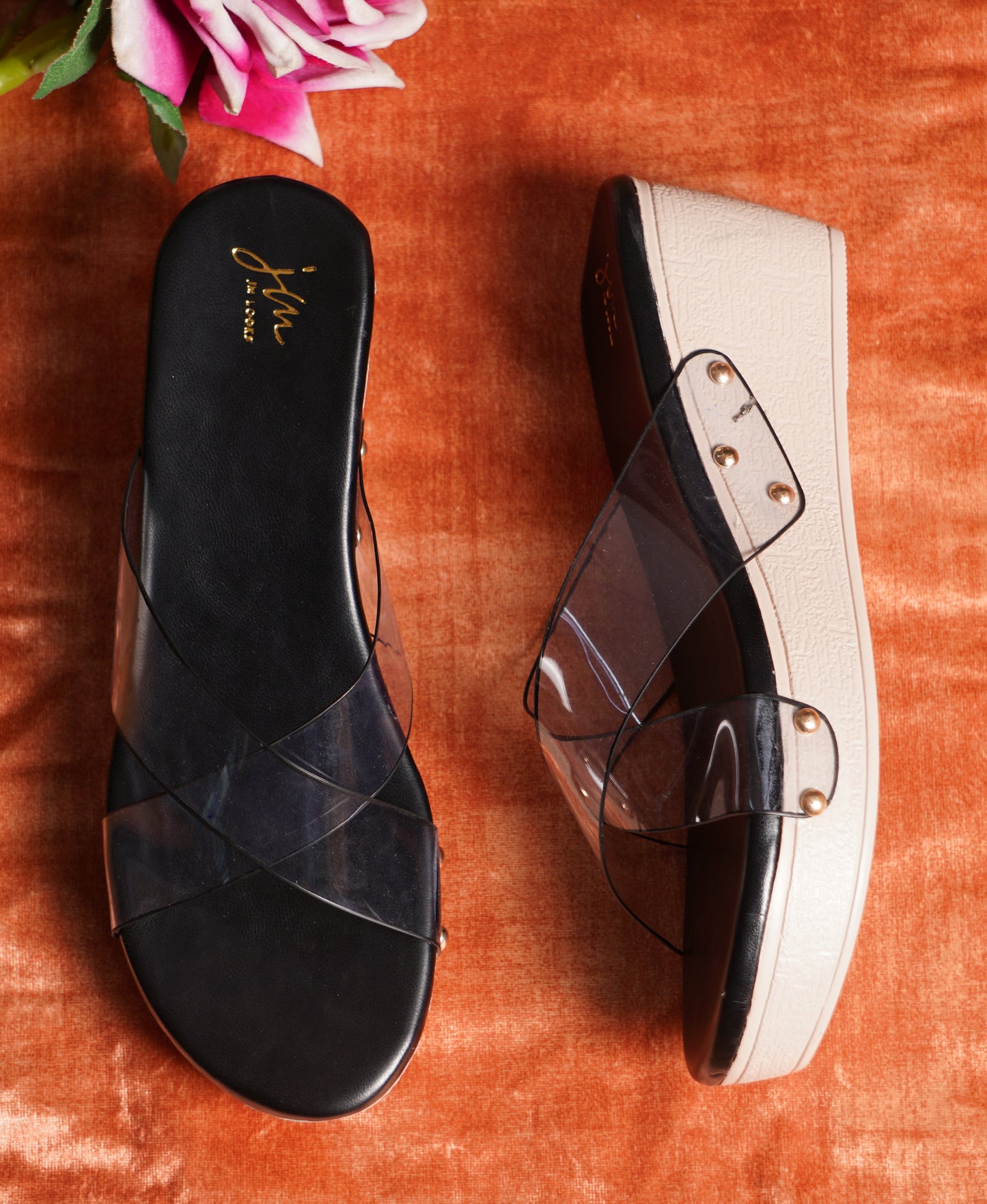 wedge heel slides featuring clear cross straps and a comfortable sole
Black