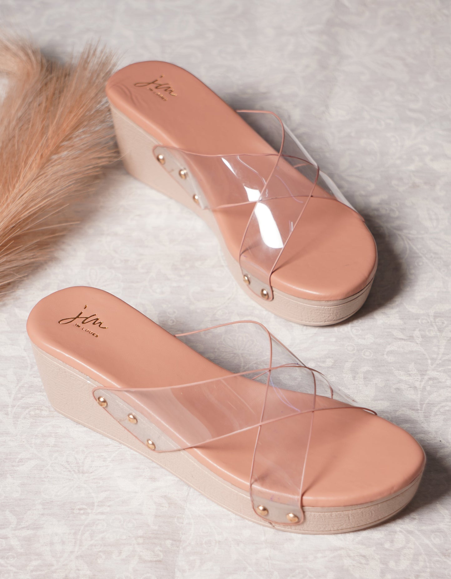 wedge heel slides featuring clear cross straps and a comfortable sole
Peach