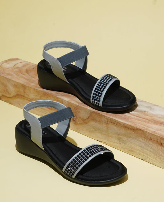 wedge sandals with an embellished front strap and an elastic ankle strap
 Grey