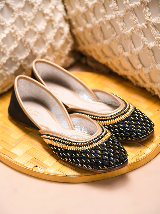 traditional juttis with intricate beaded work in a geometric pattern on the upper
 Black