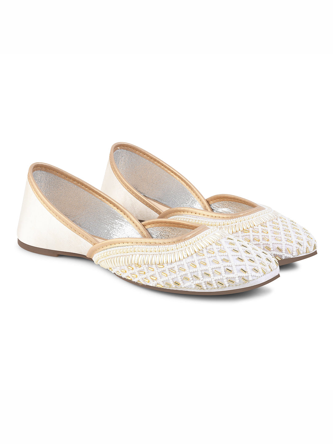 traditional juttis with intricate beaded work in a geometric pattern on the upper
White