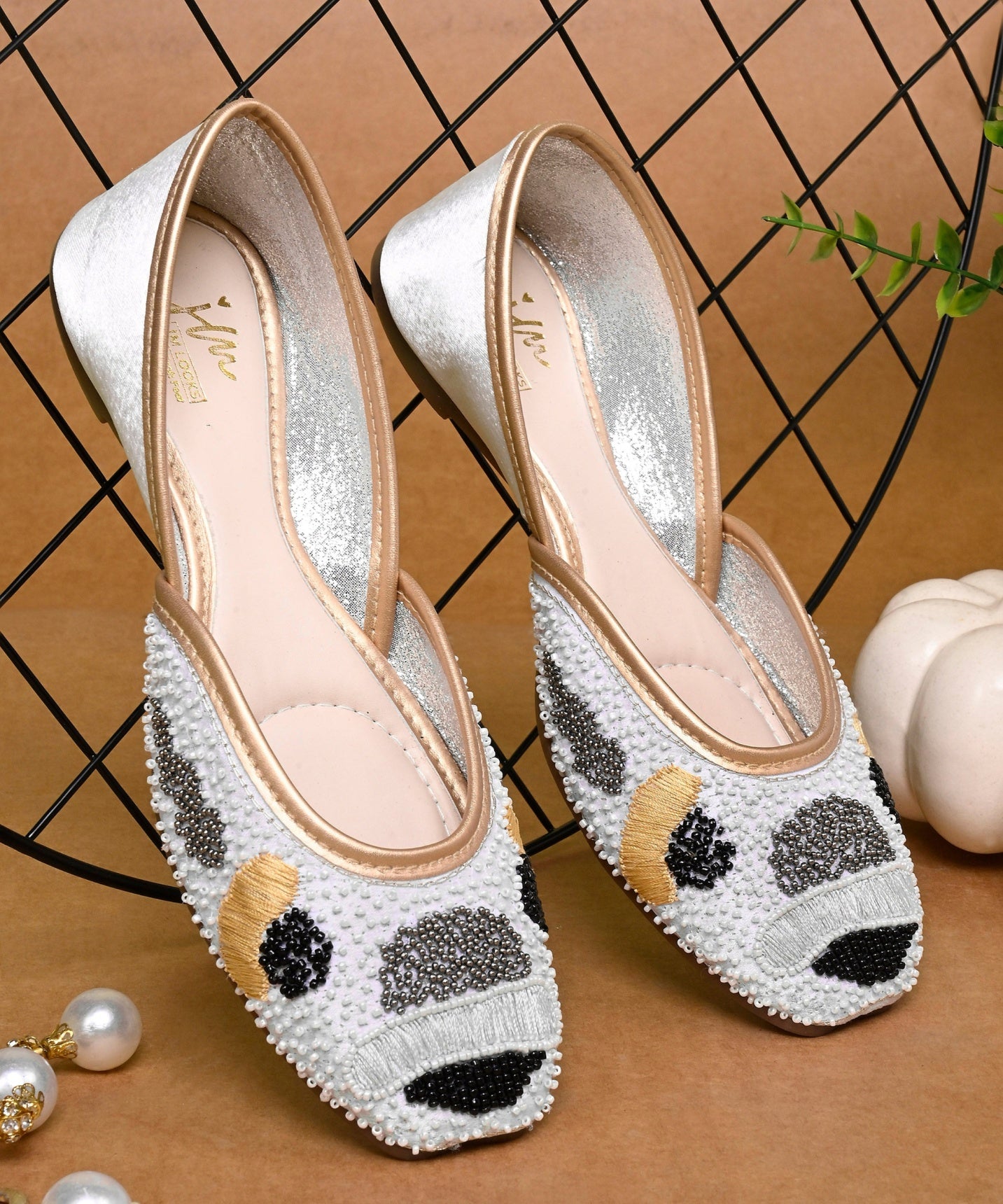 White pearl beaded ethnic jutti for women with golden piping, black bead detailing, pointed toe flat