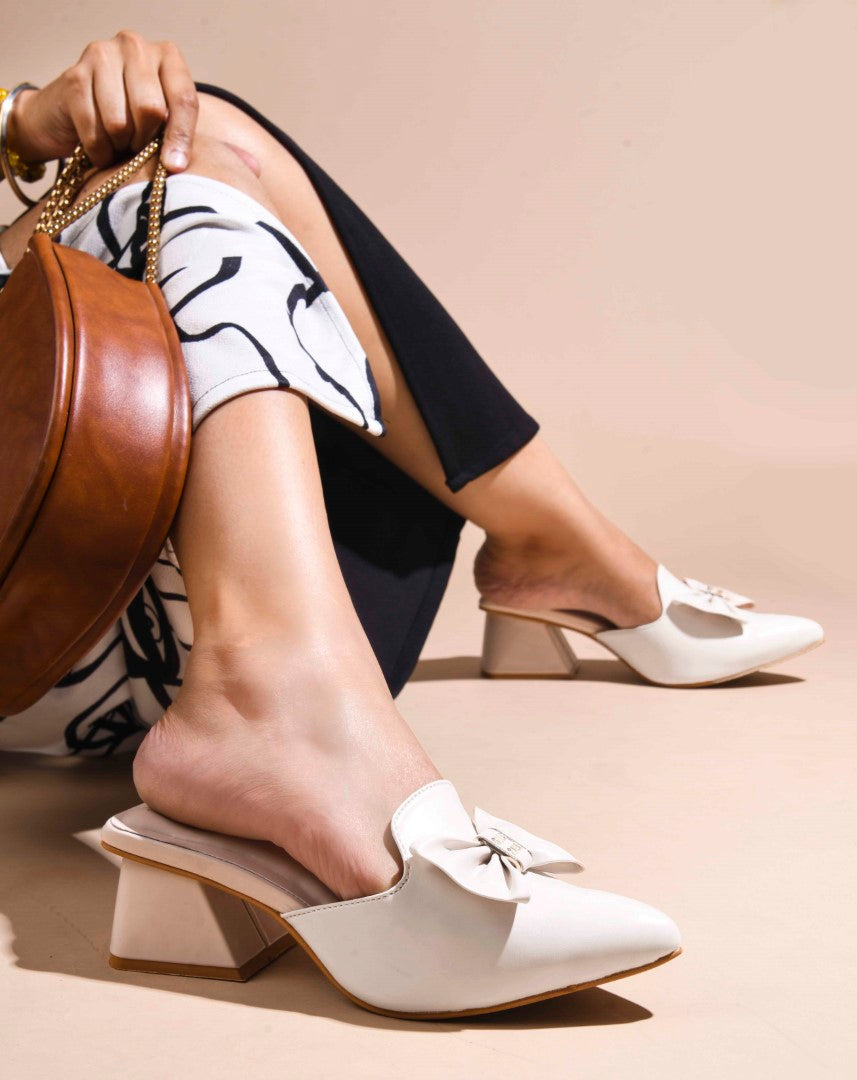 JM Looks women's pointed-toe mules with a decorative bow and a block heel
Cream
