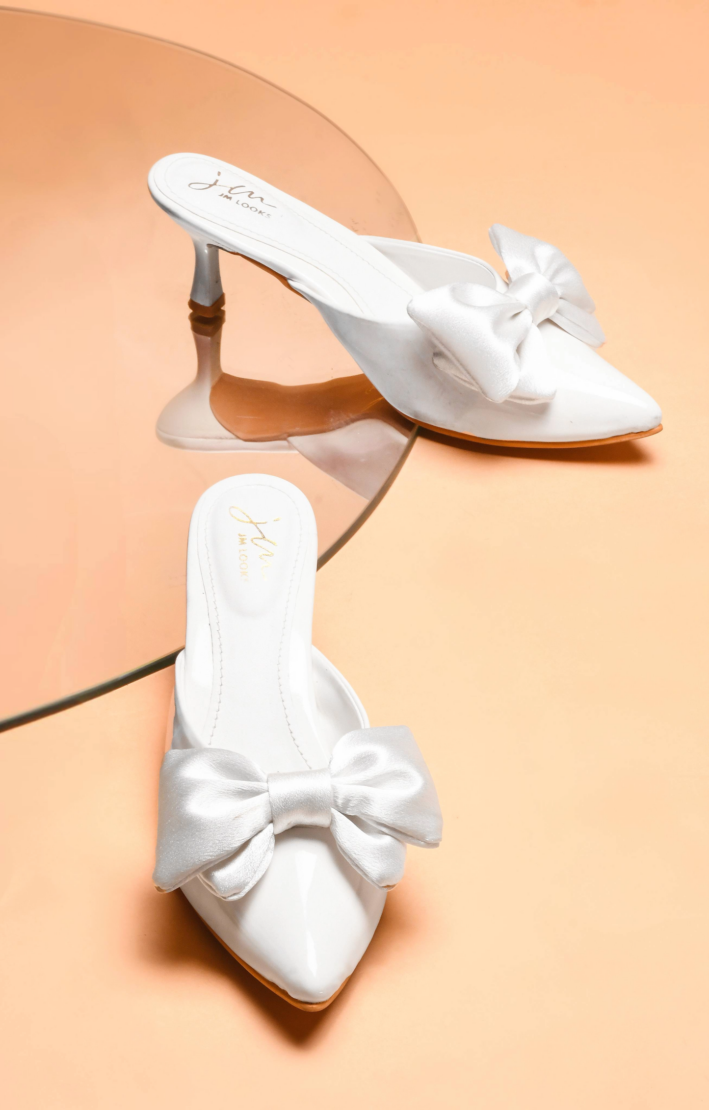 pointed toe heels featuring a large bow detail on the front
White