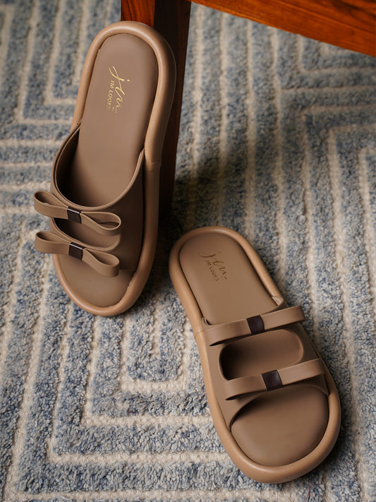 JM Looks slide sandals featuring multiple bow details on the wide straps and a flat sole
 Beige