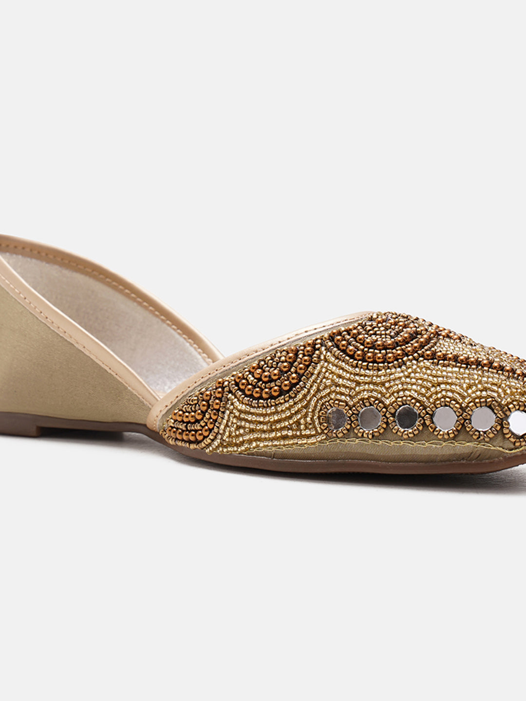 traditional juttis heavily embellished with pearls and beads on the upper
White