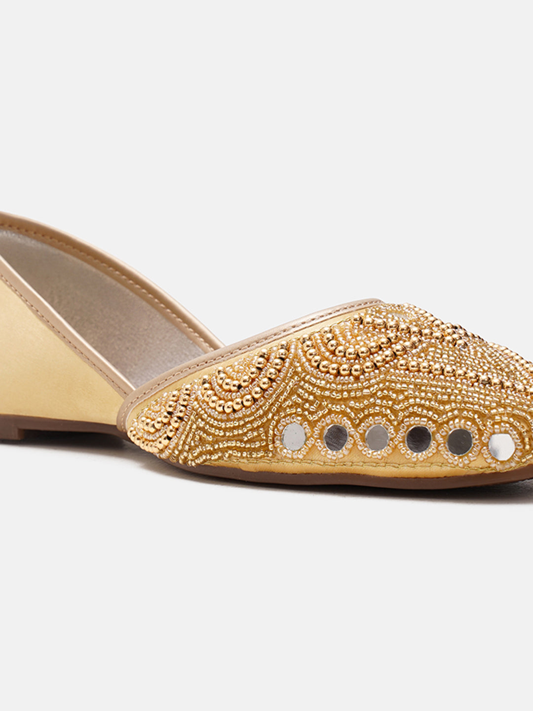 traditional juttis heavily embellished with pearls and beads on the upper
Golden