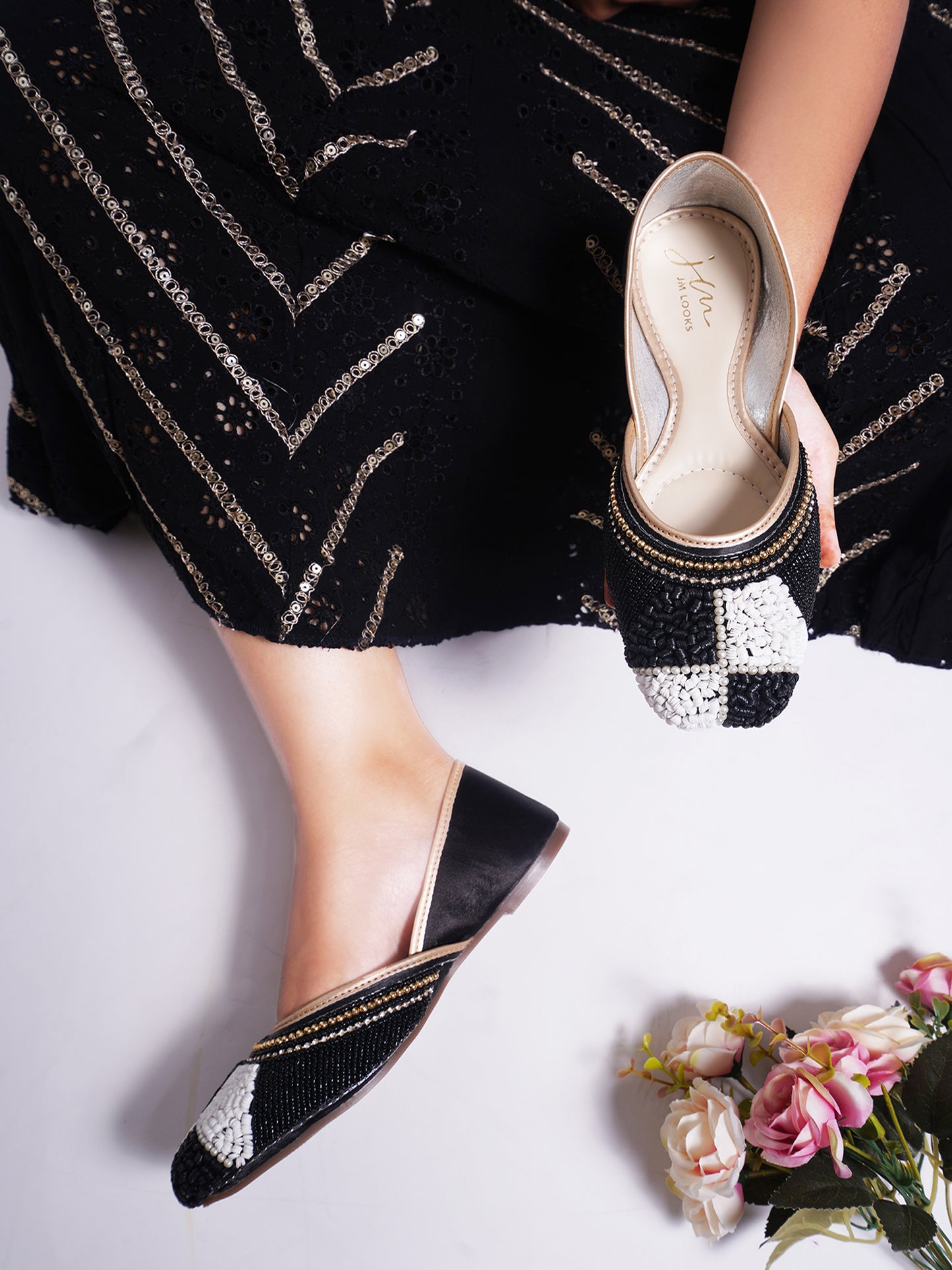juttis featuring a checkered pattern made from beads
Black