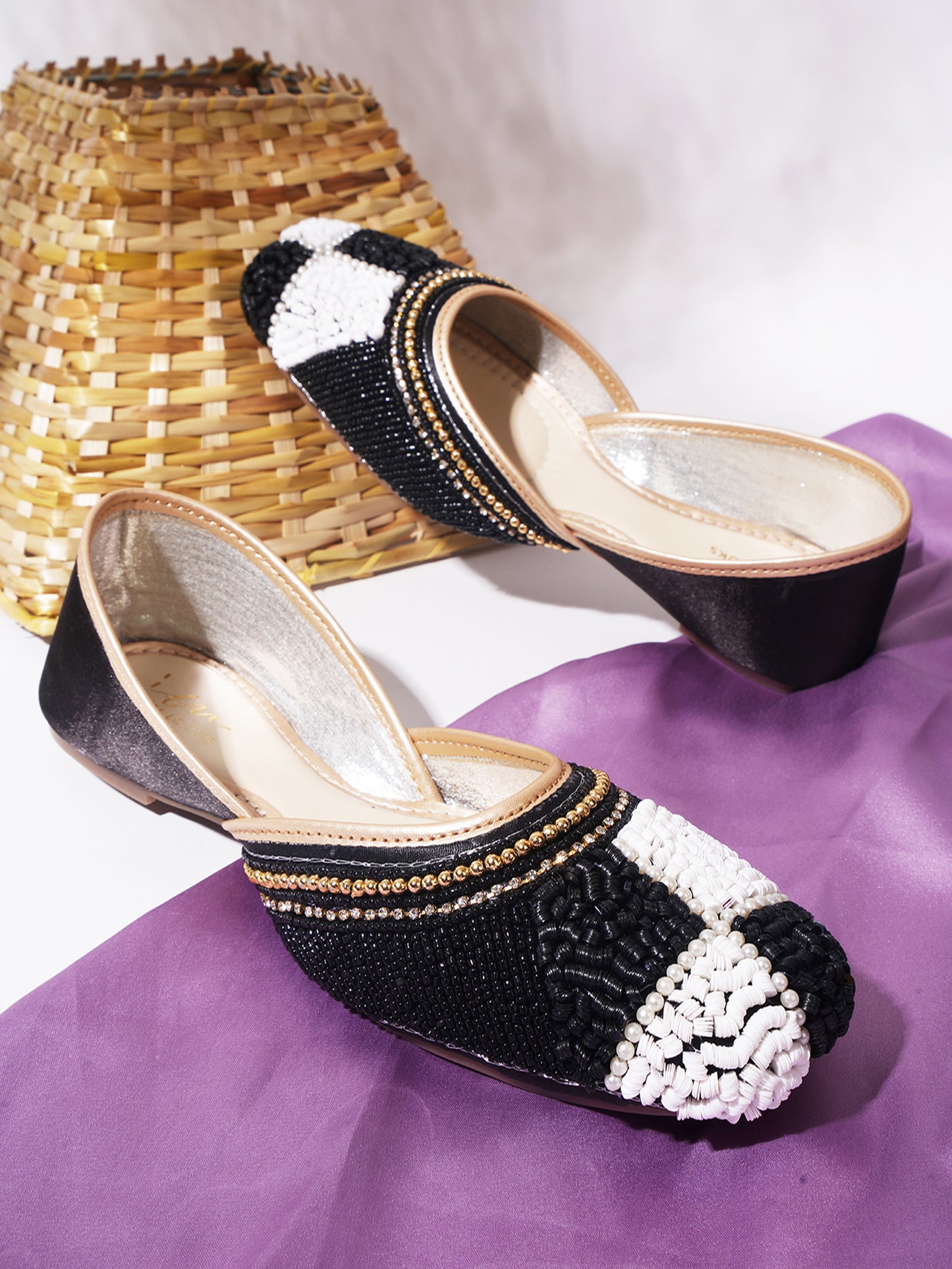 juttis featuring a checkered pattern made from beads
Black