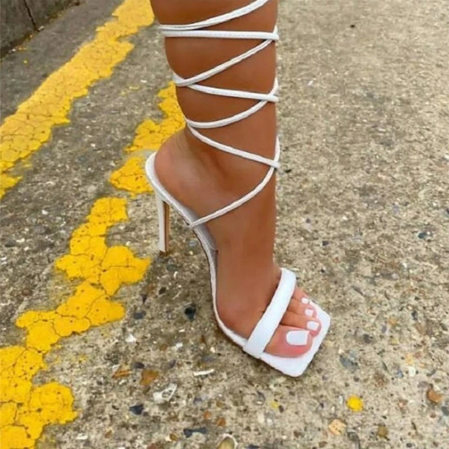 lace-up stiletto heels with thin straps wrapping around the ankles
White