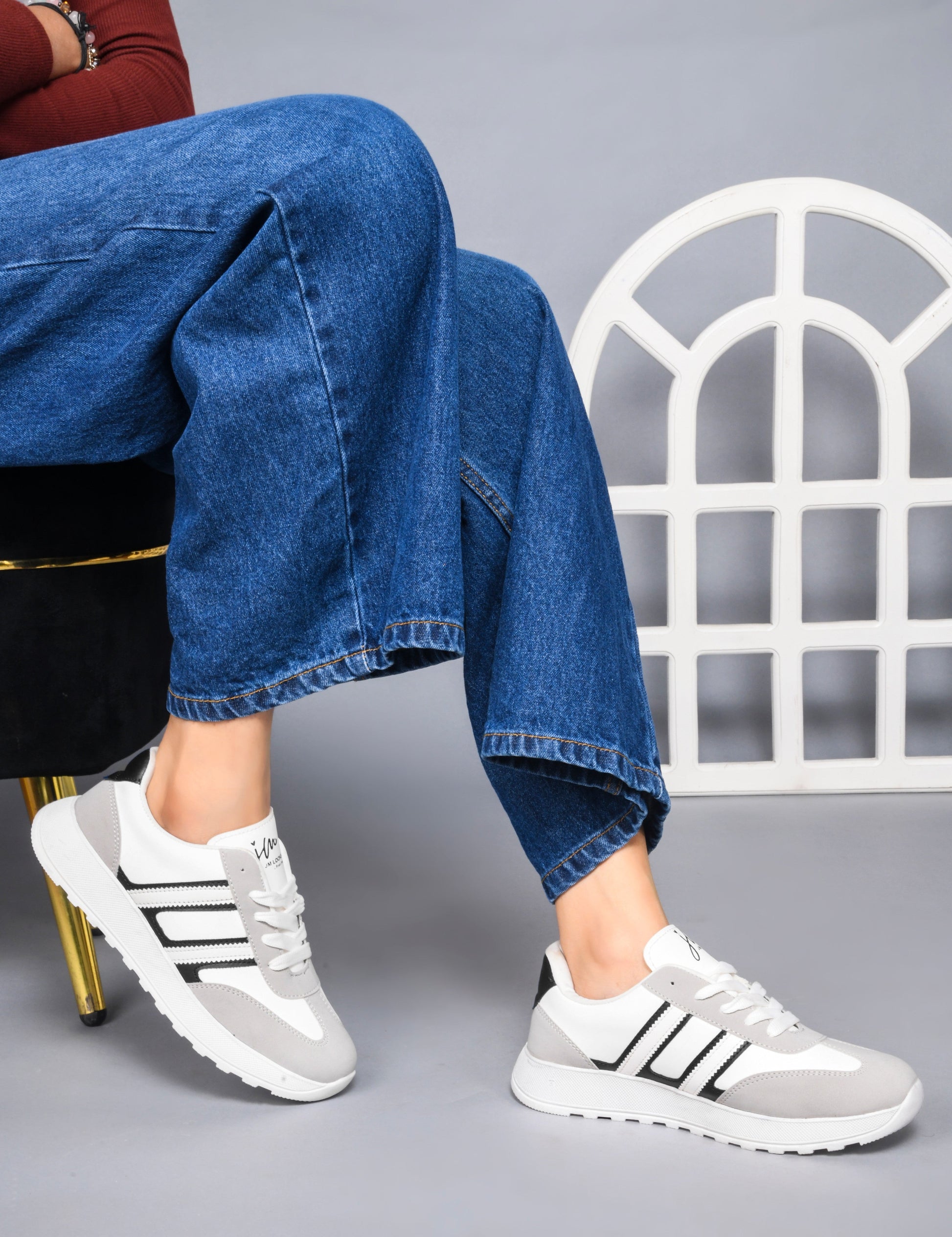 Women's lace-up casual sneakers in grey white with black stripe detailing on cushioned white platform sole
