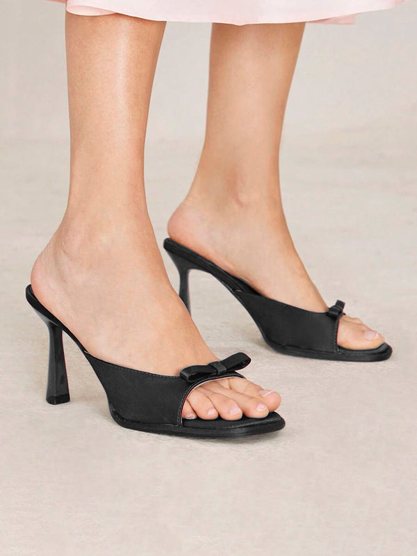 JM Looks heeled mules featuring a small bow detail on the vamp and a sculpted heel
 Black