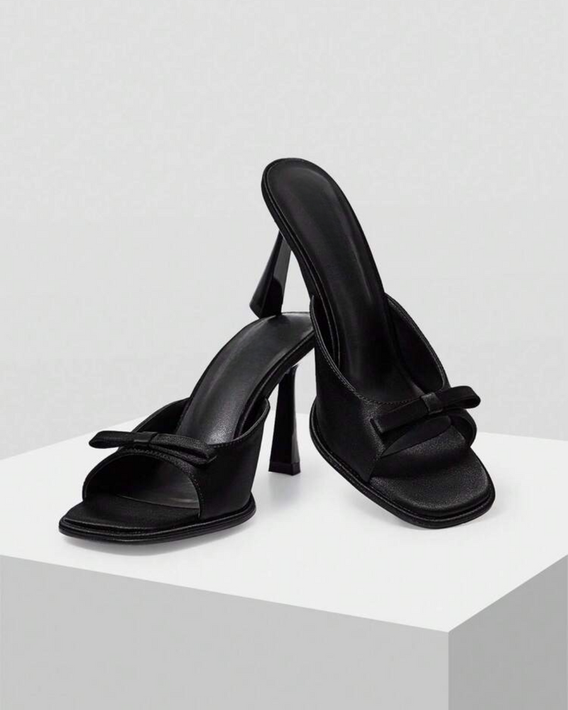 JM Looks heeled mules featuring a small bow detail on the vamp and a sculpted heel
 Black