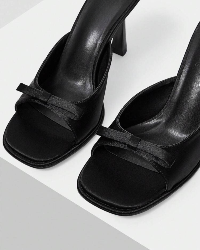 JM Looks heeled mules featuring a small bow detail on the vamp and a sculpted heel
 Black