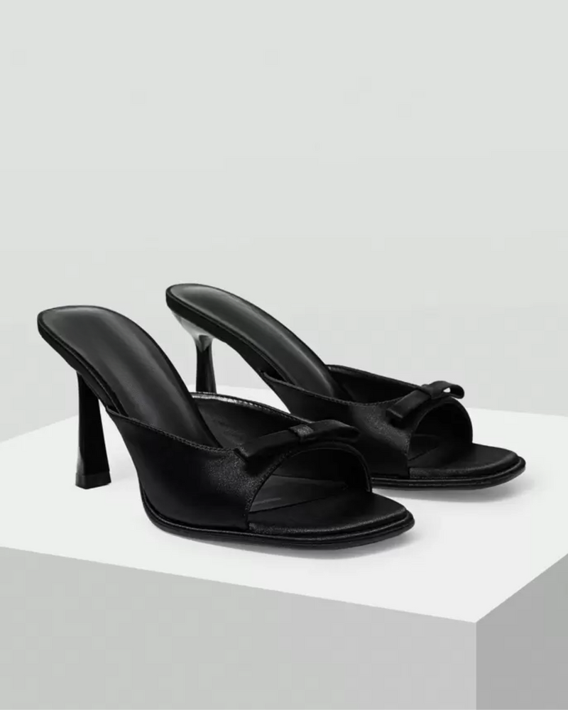 JM Looks heeled mules featuring a small bow detail on the vamp and a sculpted heel
 Black